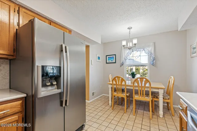 a dining room with furniture a chandelier and window