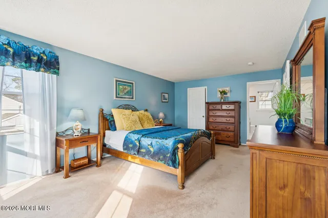 a bedroom with a bed and a potted plant