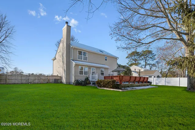 a front view of a house with a garden and plants