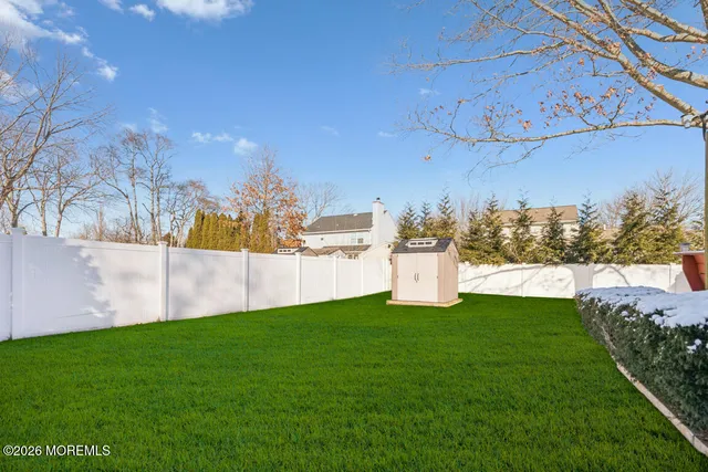 a view of a house with a yard and a garage