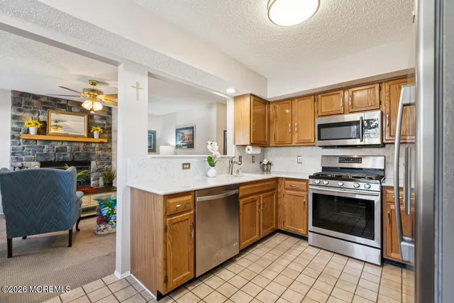 a kitchen with stainless steel appliances granite countertop a stove and a sink