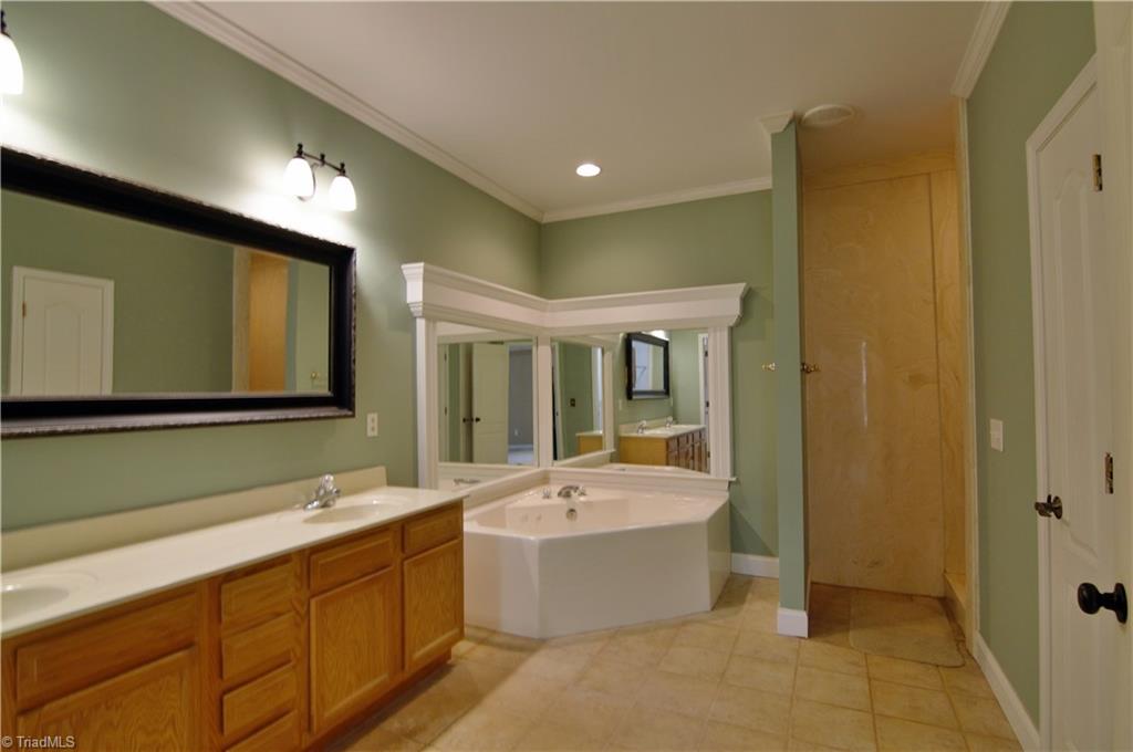 293 Winding Ridge Lane Lexington, NC 27292 - Photo 21 of 27 Master bath with dual vanity, jetted tub, separate walk in shower and tiled flooring
