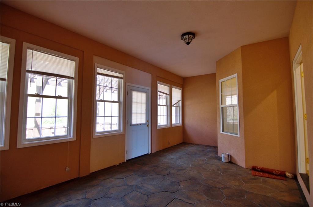 293 Winding Ridge Lane Lexington, NC 27292 - Photo 27 of 27 Sun room off living room with stamped concrete flooring
