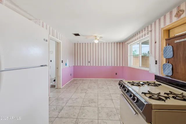 an empty room with wooden floor and window