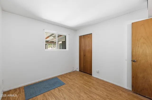 an empty room with closet area