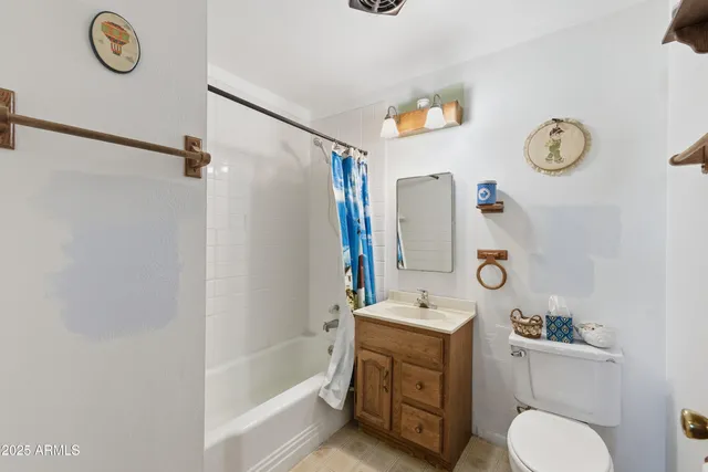 a view of a hallway with a chandelier fan