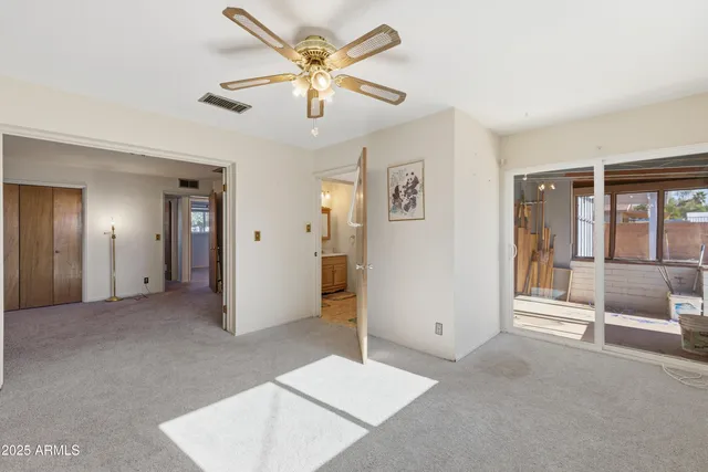 a view of a porch with a table and chairs