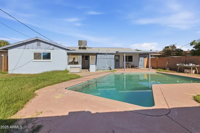 an aerial view of residential houses with outdoor space and parking
