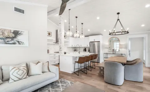 a view of a patio with a table chairs and a floor to ceiling window