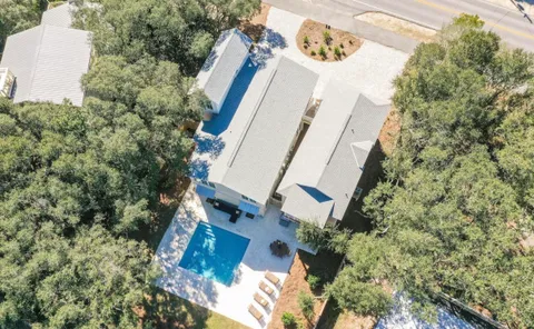 an aerial view of a house with a yard