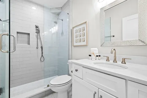 a bathroom with a sink toilet and shower
