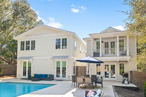 an aerial view of residential houses with outdoor space and trees