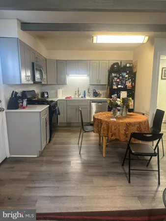 a kitchen with a table chairs stove and cabinets