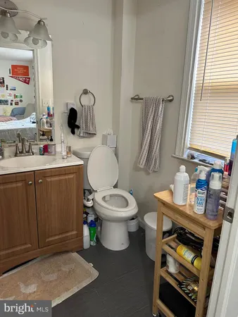 a white toilet sitting next to a bathroom sink