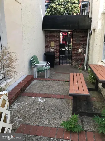 a living room with furniture a fireplace and a table