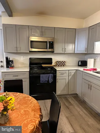 a kitchen with a stove a sink and a microwave