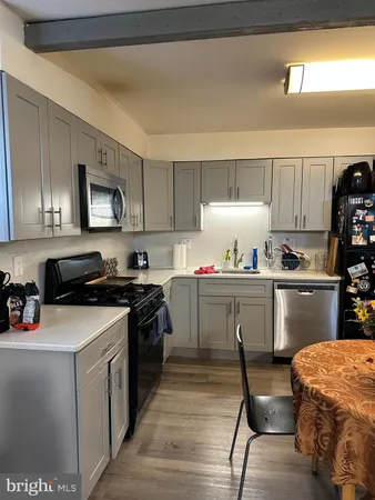a kitchen with a sink a stove and cabinets