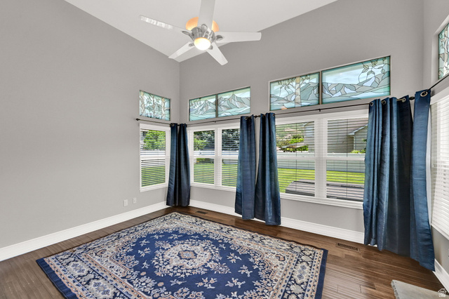 4792 Glasmann Way South Ogden, UT 84403 - Photo 40 of 70 Vaulted ceiling with a ceiling fan and recessed lighting, wood-finish flooring, and multiple windows with stained glass transoms