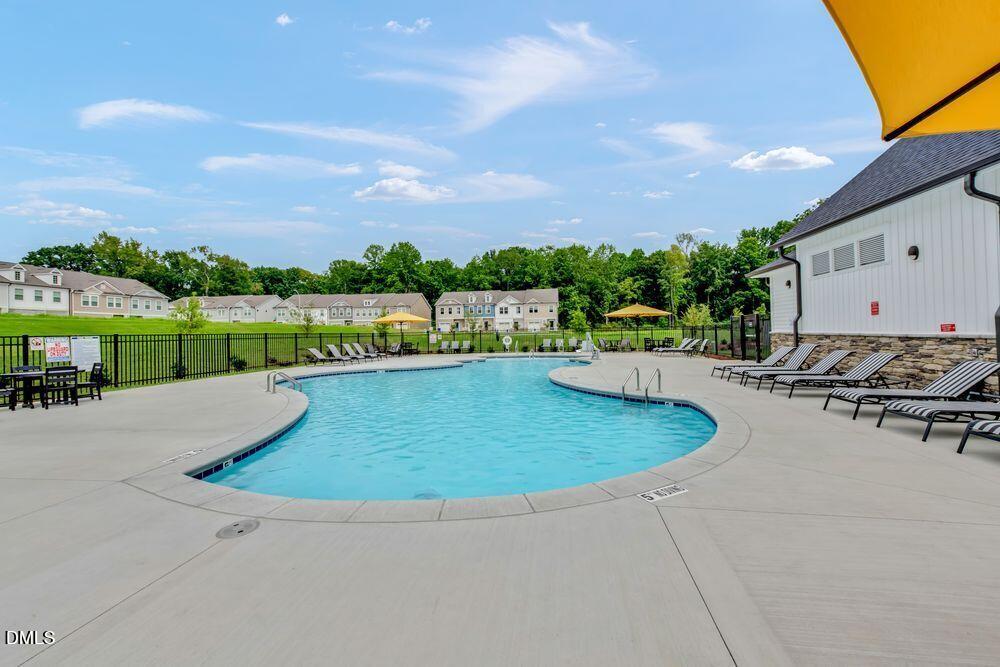 55 Shay Street Angier, NC 27501 - Photo 18 of 54 a view of a swimming pool with a patio and a yard