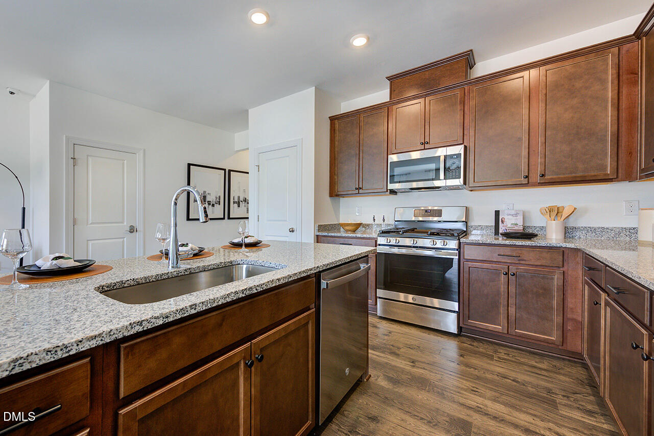 55 Shay Street Angier, NC 27501 - Photo 7 of 54 a kitchen with granite countertop a sink stove and cabinets