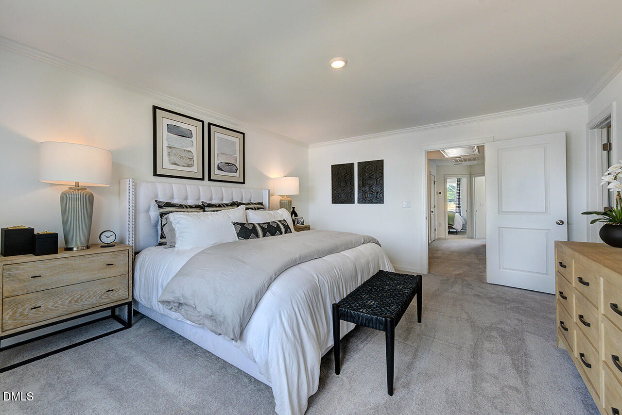 55 Shay Street Angier, NC 27501 - Photo 10 of 54 a spacious bedroom with a bed a mirror and lamp