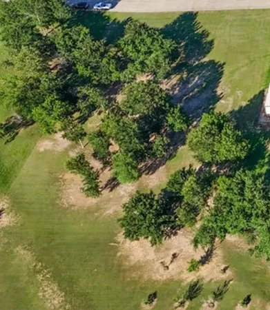 a view of a lake with beach and green space