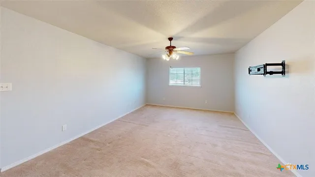 a large kitchen with stainless steel appliances a large counter top and a view of living room