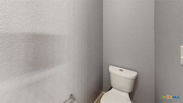 a view of an empty room with a ceiling fan