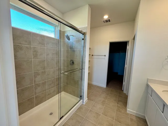 a bathroom with a shower and a sink