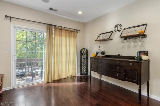 a view of a balcony with chair and wooden floor