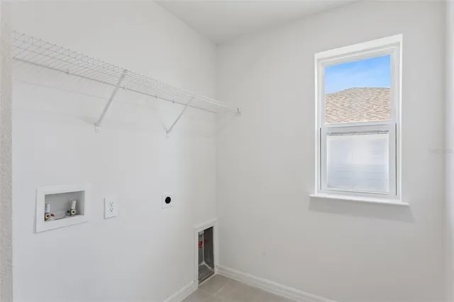 a view of a house with a big yard and potted plants