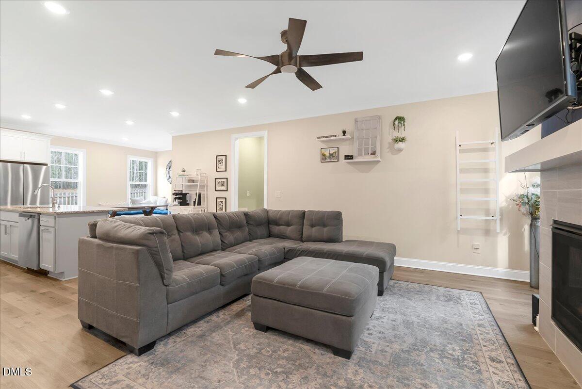 1208 Montgomery Road Franklinton, NC 27525 - Photo 8 of 62 a living room with furniture a flat screen tv and a fireplace
