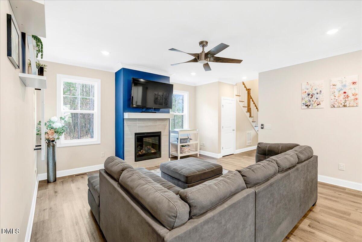 1208 Montgomery Road Franklinton, NC 27525 - Photo 11 of 62 a living room with furniture a flat screen tv and a fireplace