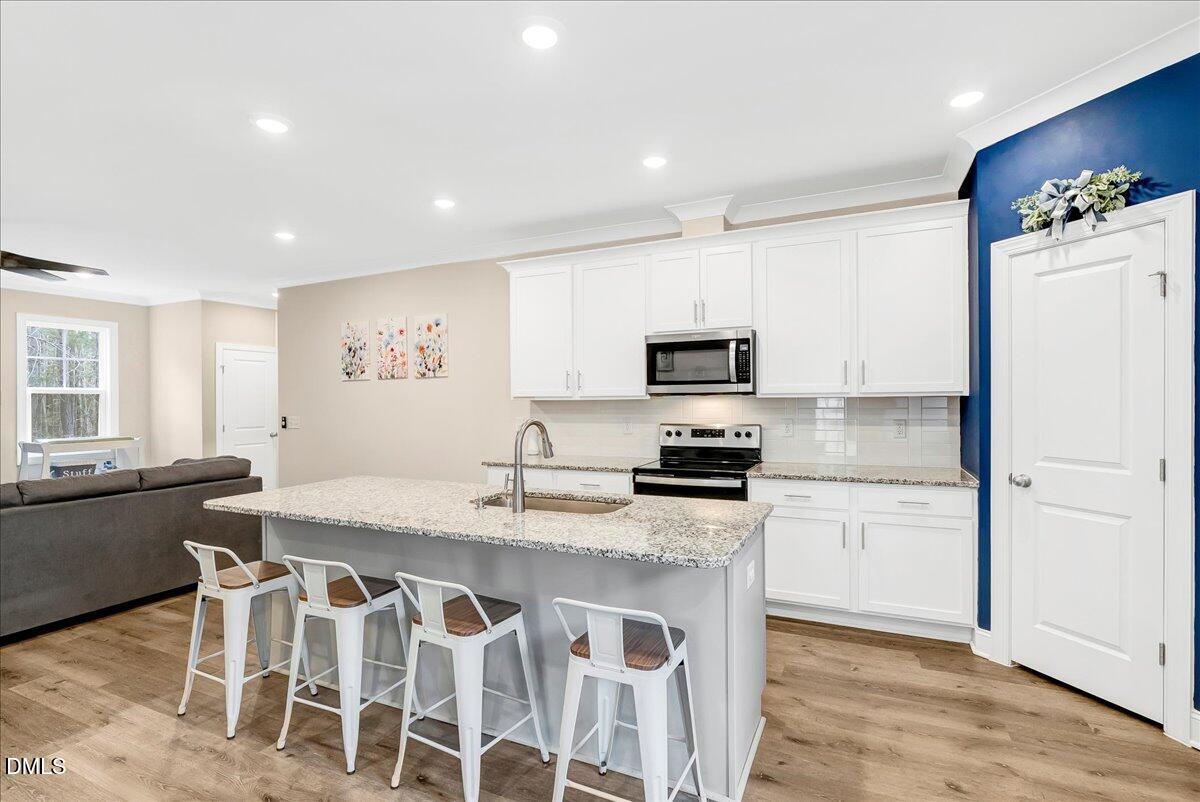 1208 Montgomery Road Franklinton, NC 27525 - Photo 14 of 62 a kitchen with granite countertop cabinets a counter space and stainless steel appliances