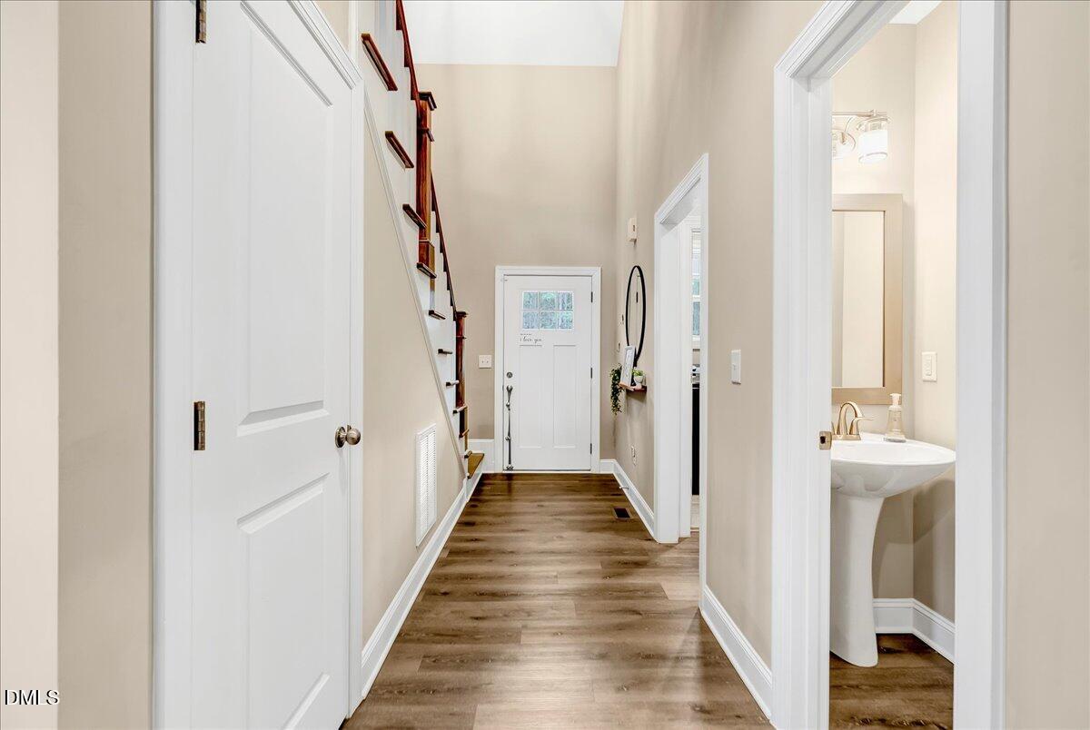 1208 Montgomery Road Franklinton, NC 27525 - Photo 2 of 62 a view of a hallway with wooden floor and staircase
