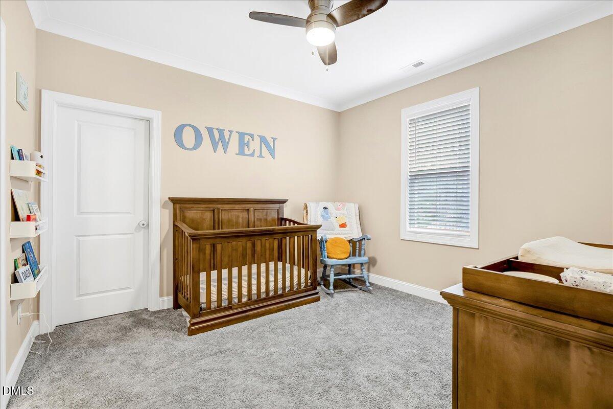 1208 Montgomery Road Franklinton, NC 27525 - Photo 24 of 62 a bedroom with a baby bed a couch and a window
