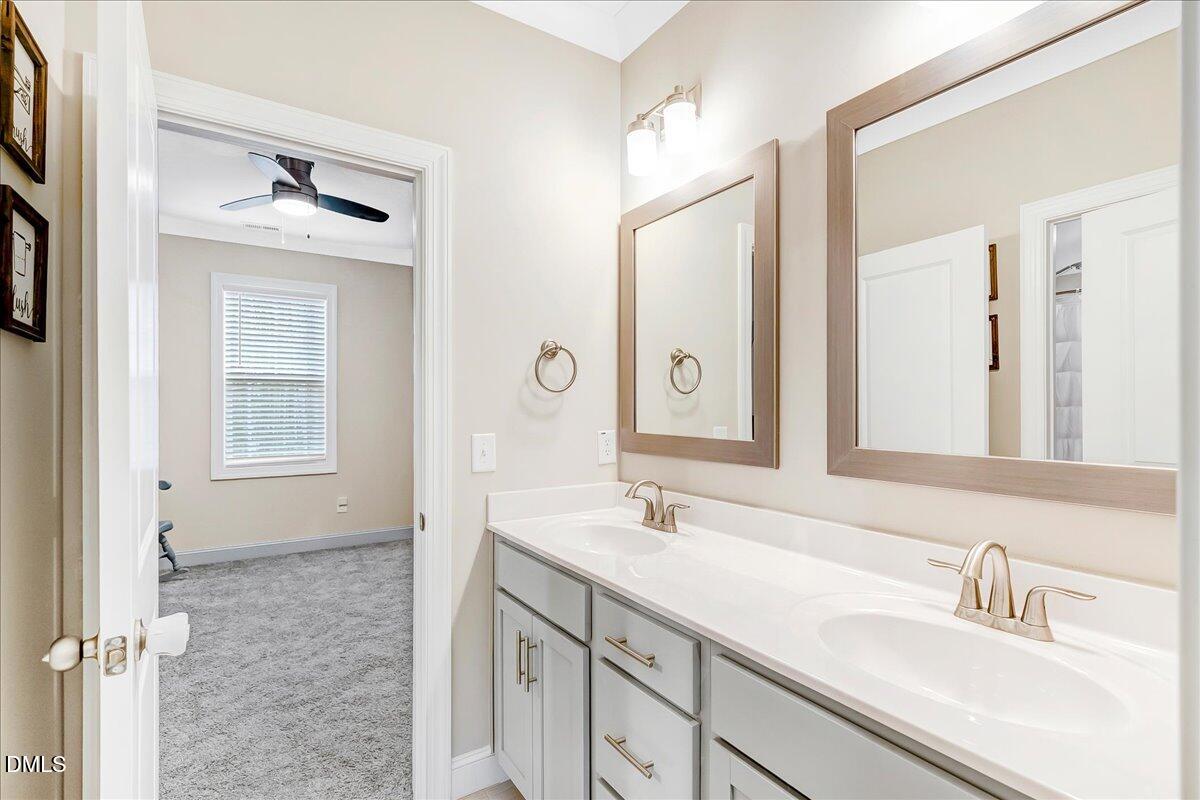 1208 Montgomery Road Franklinton, NC 27525 - Photo 28 of 62 a bathroom with a double vanity sink a mirror and