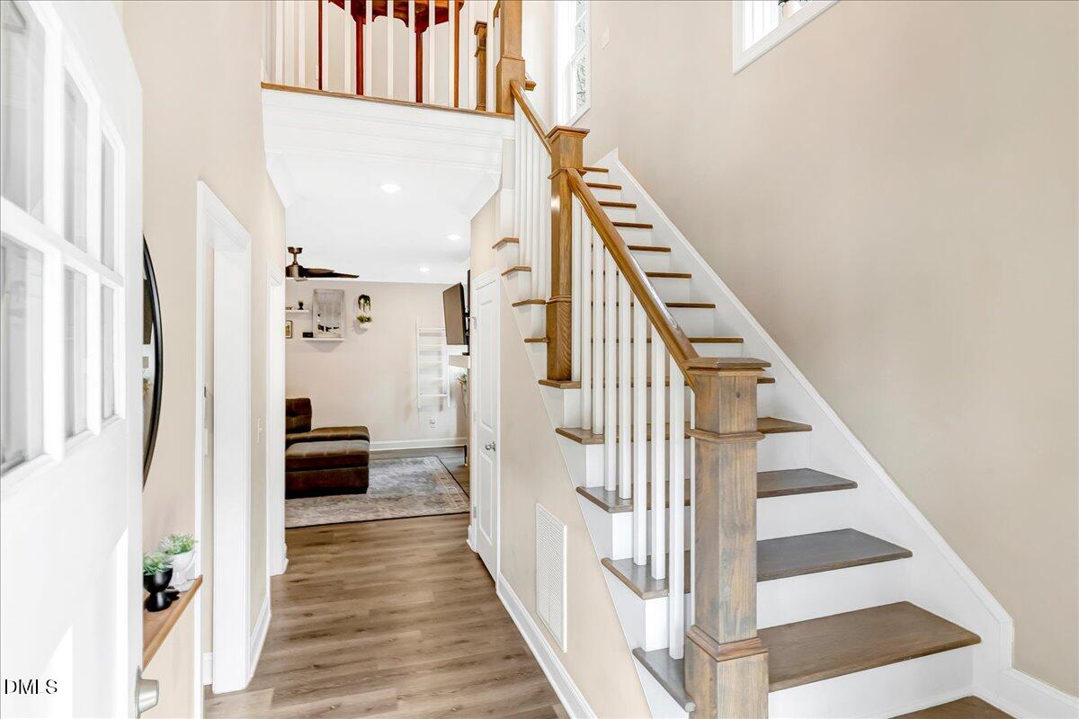 1208 Montgomery Road Franklinton, NC 27525 - Photo 36 of 62 a view of staircase with lots of frames on wall and a window