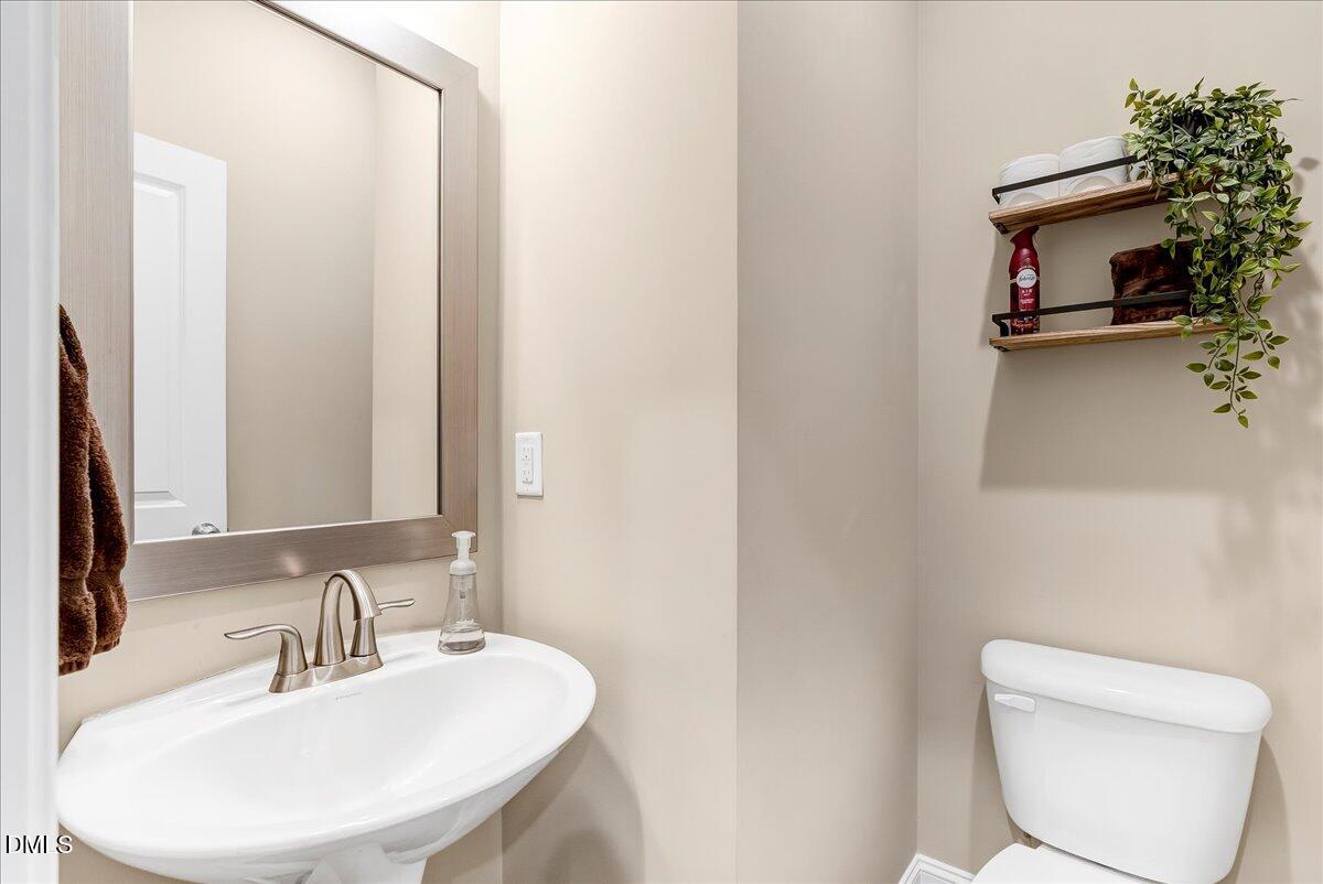 1208 Montgomery Road Franklinton, NC 27525 - Photo 3 of 62 a bathroom with a toilet a sink and mirror