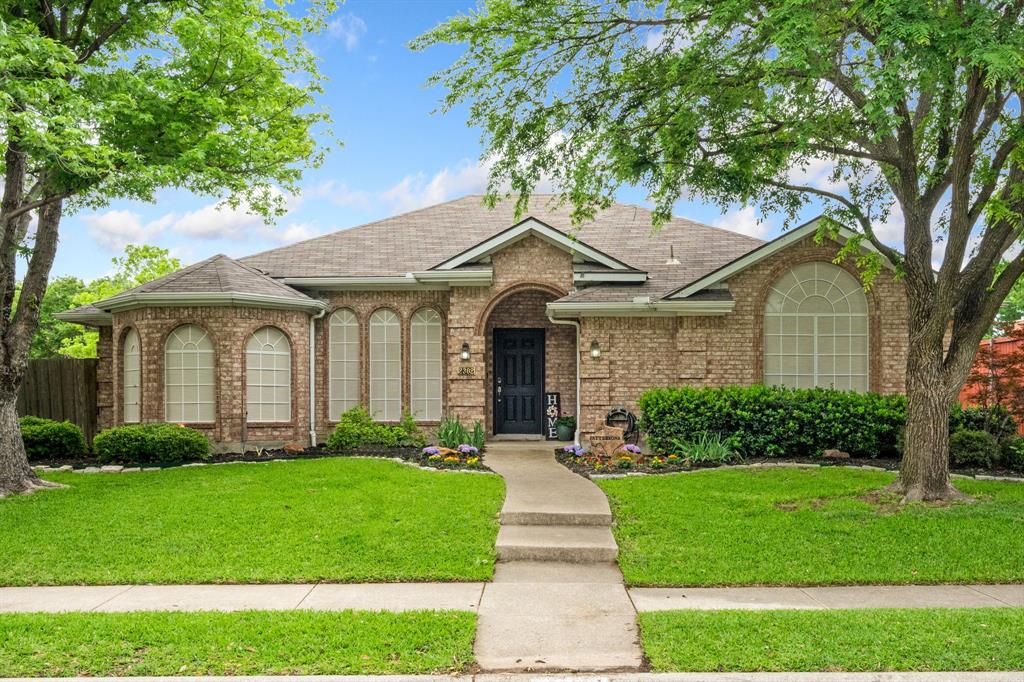 2302 Randi Road Rowlett, TX 75088 - Photo 1 of 33 a front view of a house with a yard and potted plants