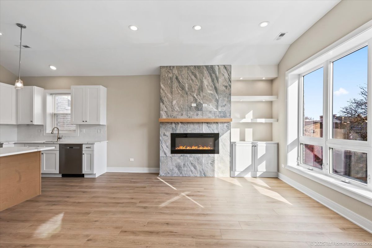 4932 South Champlain Avenue Chicago, IL 60615 - Photo 4 of 27 a large kitchen with a fireplace and a window