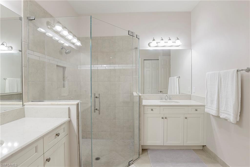 13435 Silktail Drive Naples, FL 34109 - Photo 11 of 27 a spacious bathroom with a shower and a sink