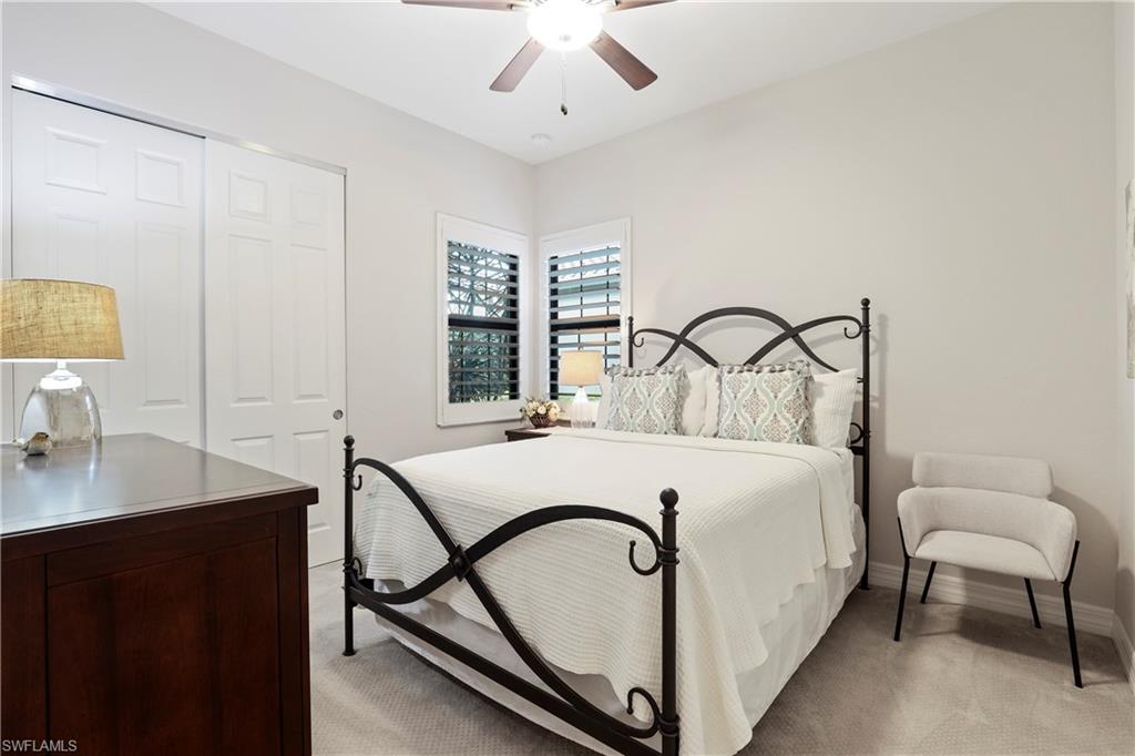 13435 Silktail Drive Naples, FL 34109 - Photo 15 of 27 a bedroom with a bed and a desk