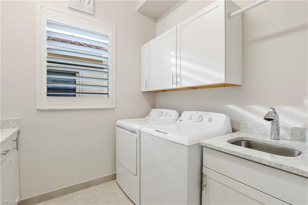 13435 Silktail Drive Naples, FL 34109 - Photo 16 of 27 a utility room with dryer and washer