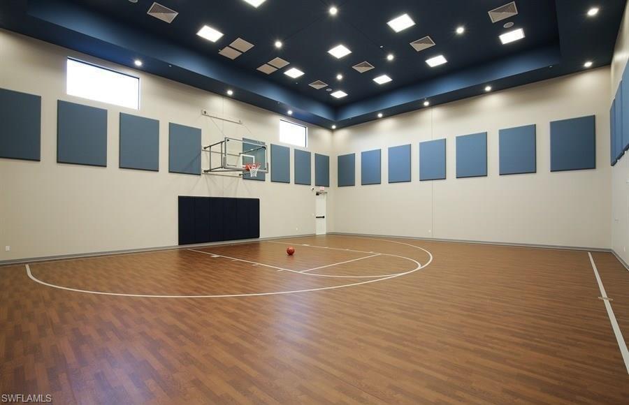 13435 Silktail Drive Naples, FL 34109 - Photo 25 of 27 a view of an empty room with wooden floor and windows