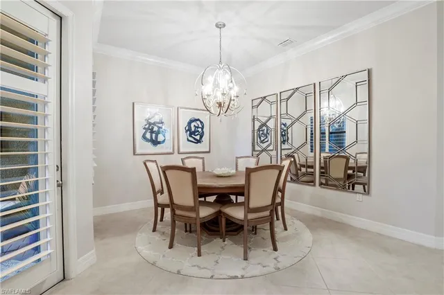 a view of a dining room with furniture and chandelier
