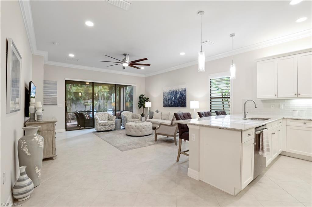 13435 Silktail Drive Naples, FL 34109 - Photo 5 of 27 a large white kitchen with a large window