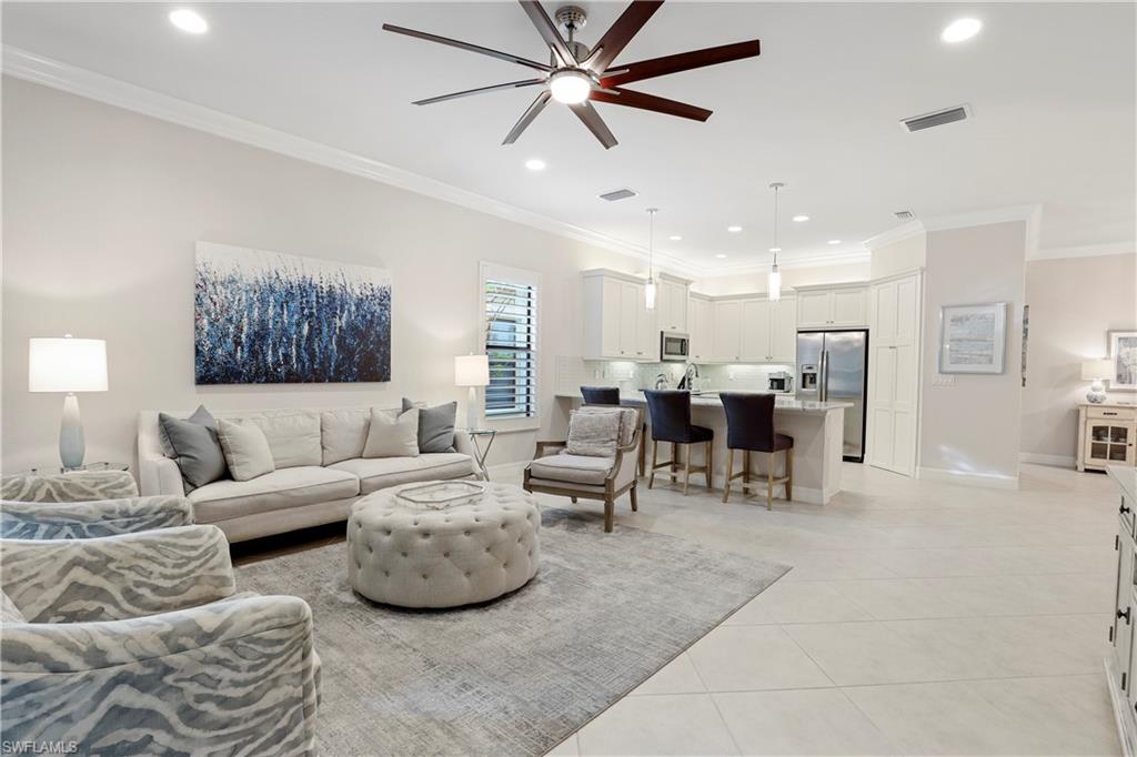 13435 Silktail Drive Naples, FL 34109 - Photo 6 of 27 a living room with furniture and kitchen view