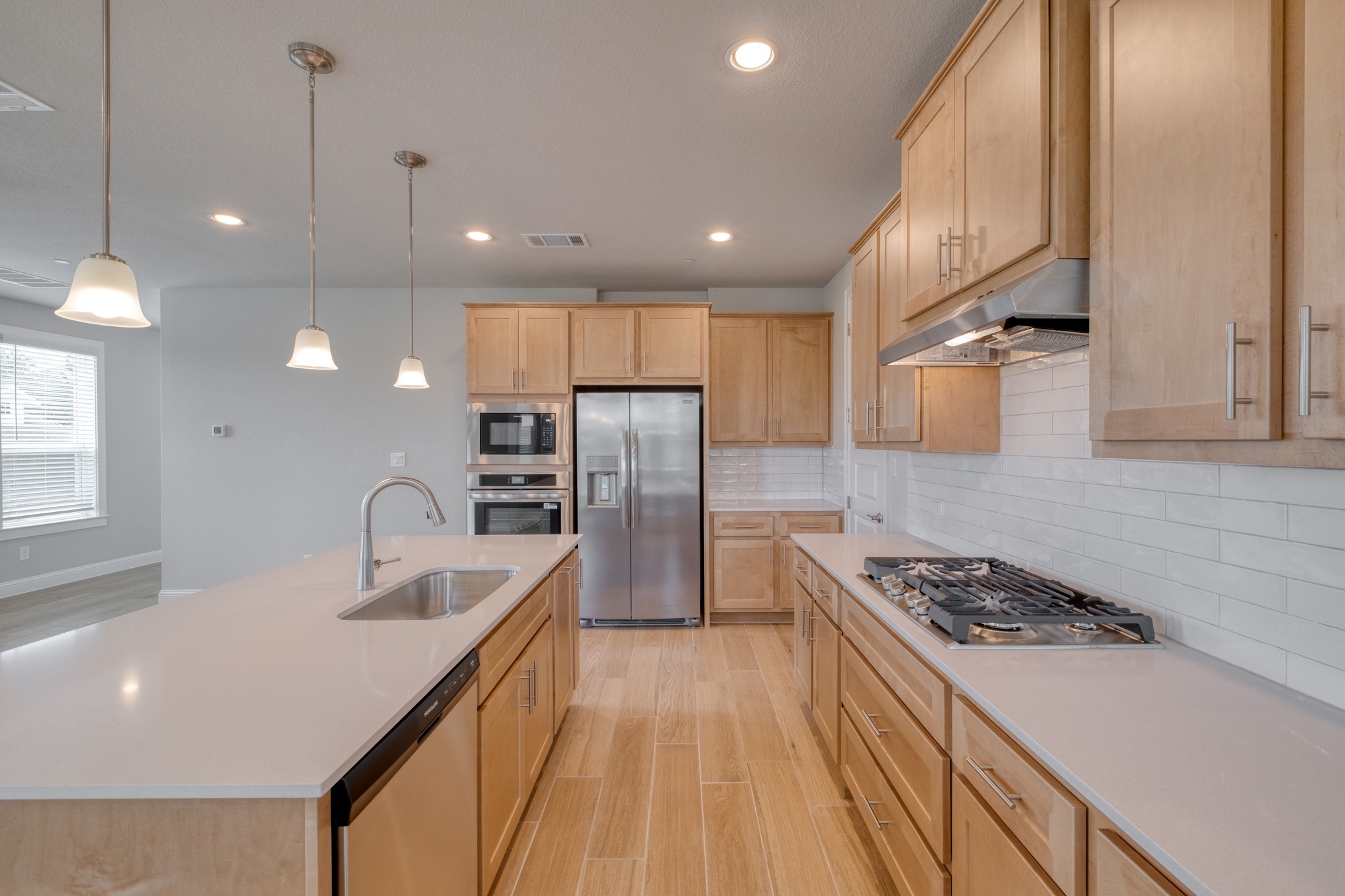 2605 Sam Bass Road, Unit 44 Round Rock, TX 78681 - Photo 11 of 26 Culinary aspirations come alive in this gourmet kitchen featuring abundant wood cabinetry, a spacious pantry and stainless-steel appliances.