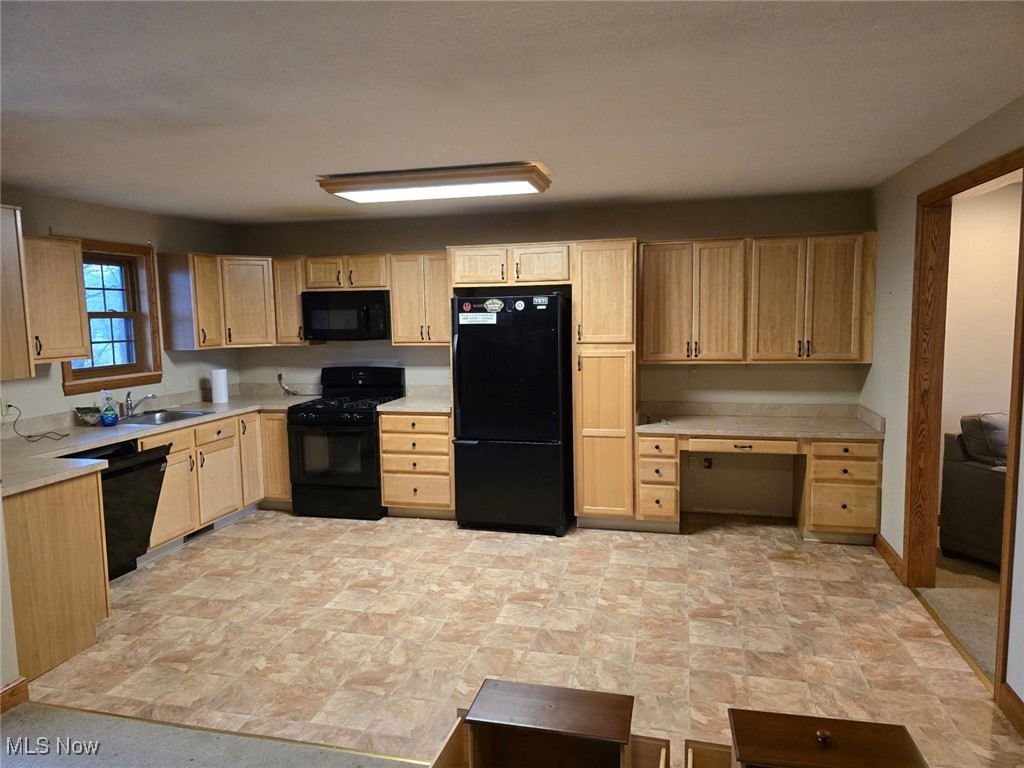 2490 Station Road Medina, OH 44256 - Photo 7 of 21 Kitchen with light brown cabinets, sink, and black appliances